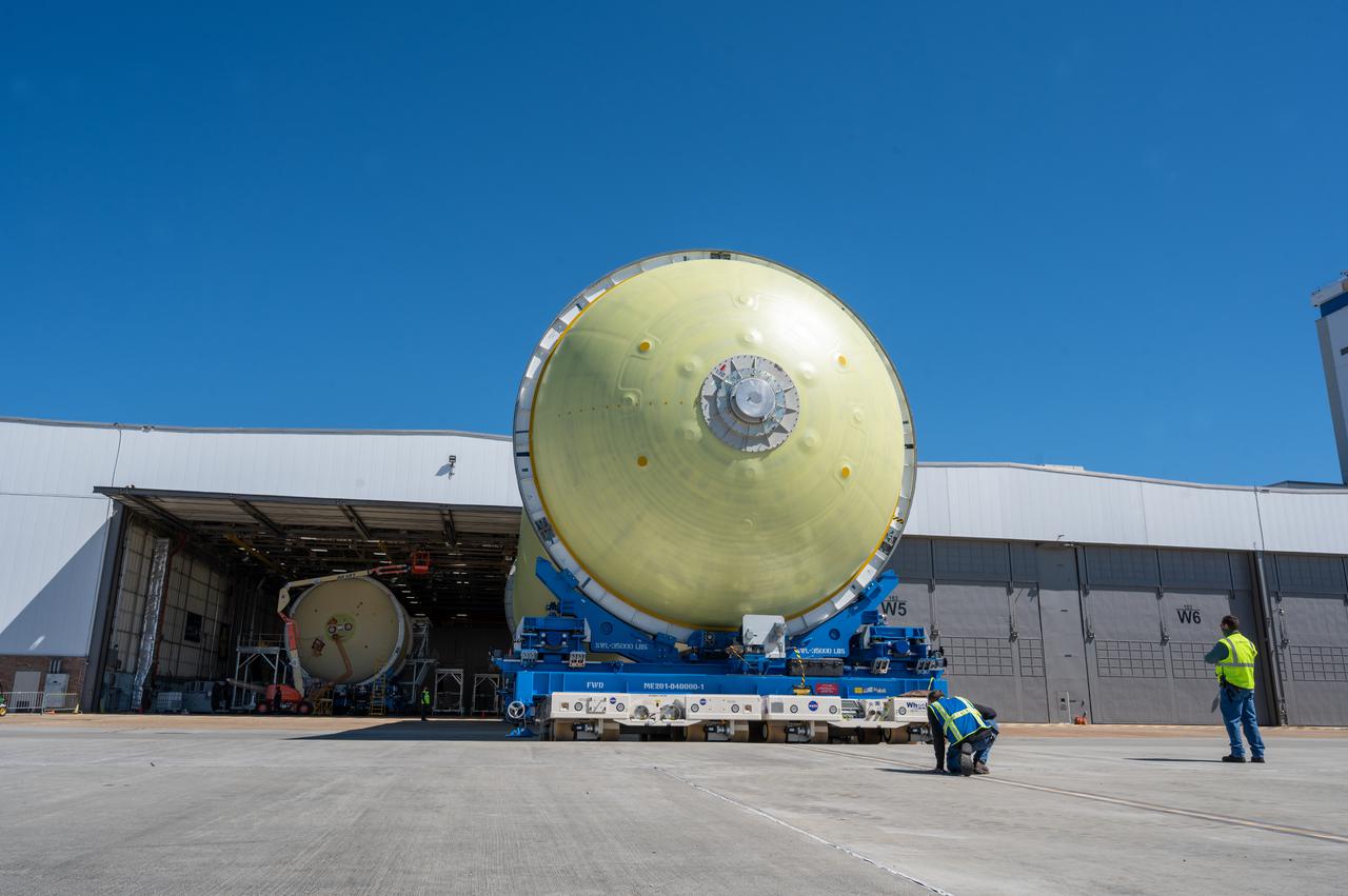 This image highlights the liquid hydrogen tank that will be used on the core stage of NASA’s Space Launch System rocket for Artemis II, the first crewed mission of NASA’s Artemis program. The tank is being built at NASA’s Michoud Assembly Facility in New Orleans. The SLS core stage is made up of five unique elements: the forward skirt, liquid oxygen tank, intertank, liquid hydrogen tank, and the engine section. The liquid hydrogen tank holds 537,000 gallons of liquid hydrogen cooled to minus 423 degrees Fahrenheit and sits between the core stage’s intertank and engine section. The liquid hydrogen hardware, along with the liquid oxygen tank, will provide propellant to the four RS-25 engines at the bottom of the cores stage to produce more than two million pounds of thrust to launch NASA’s Artemis missions to the Moon. Together with its four RS-25 engines, the rocket’s massive 212-foot-tall core stage — the largest stage NASA has ever built — and its twin solid rocket boosters will produce 8.8 million pounds of thrust to send NASA’s Orion spacecraft, astronauts and supplies beyond Earth’s orbit to the Moon and, ultimately, Mars. Offering more payload mass, volume capability and energy to speed missions through space, the SLS rocket, along with NASA’s Gateway in lunar orbit, the human landing system, and Orion spacecraft, is part of NASA’s backbone for deep space exploration and the Artemis lunar program. No other rocket can send astronauts in Orion around the Moon in a single mission.